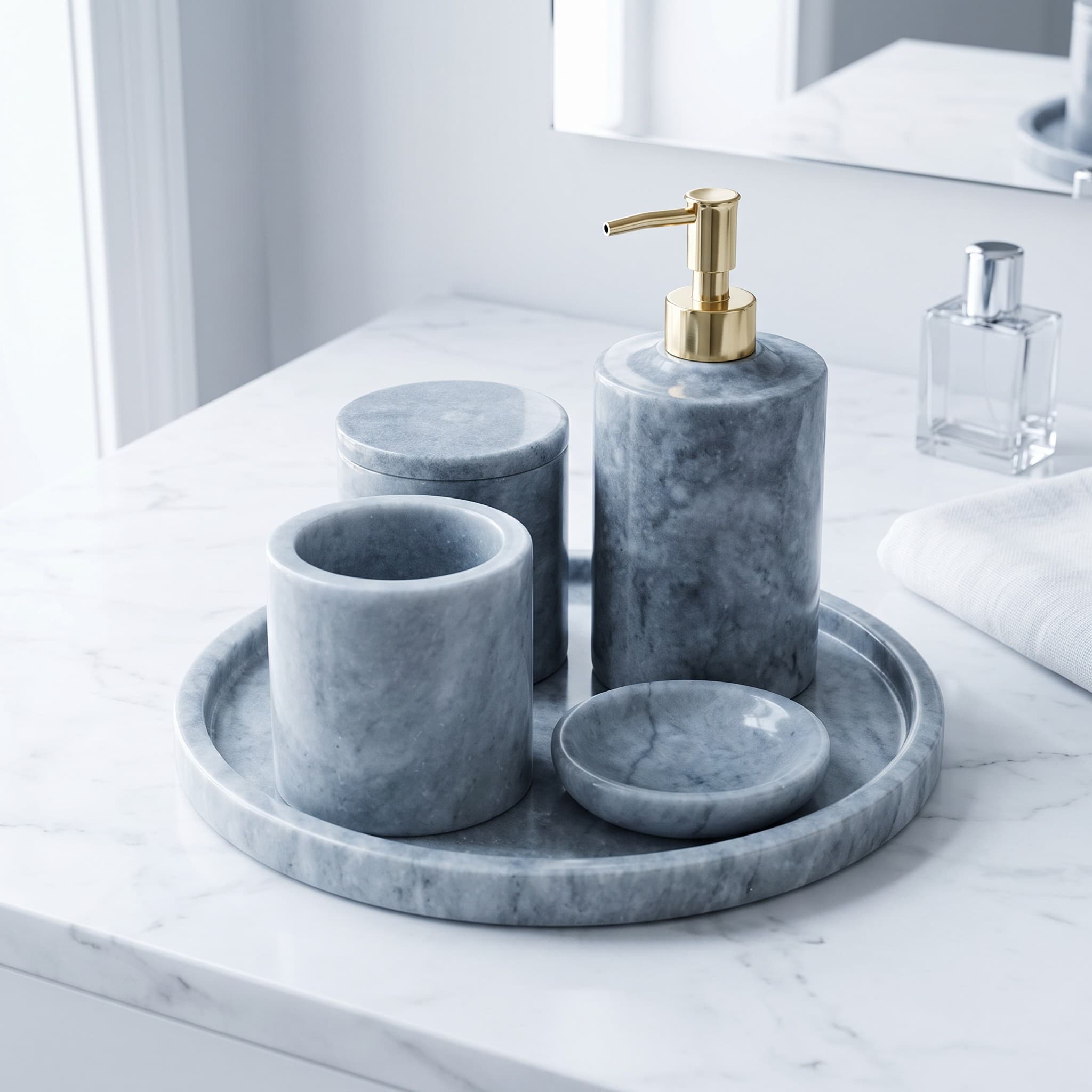 Pietra Grey marble four-piece bath set with a brass-pump soap dispenser on a round marble tray