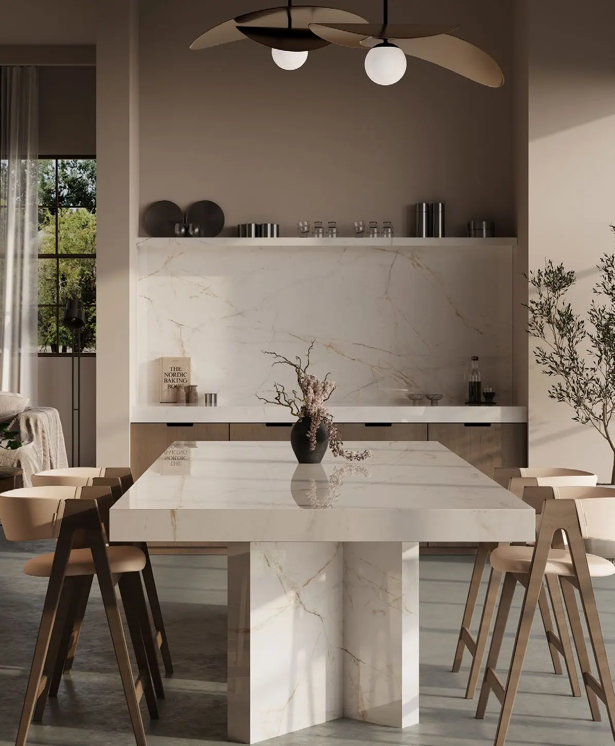 Calacatta Miele marble dining table and backsplash in a warm, sunlit kitchen salon